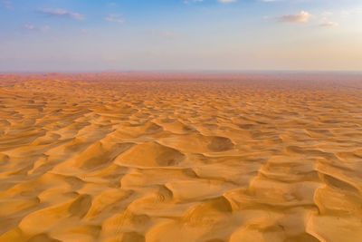 Scenic view of desert against sky during sunset