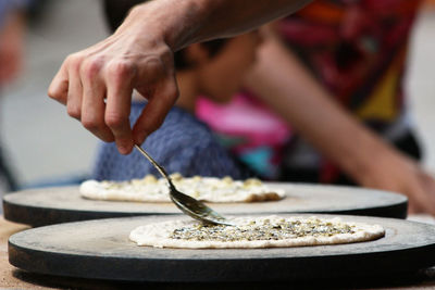 Midsection of person preparing food