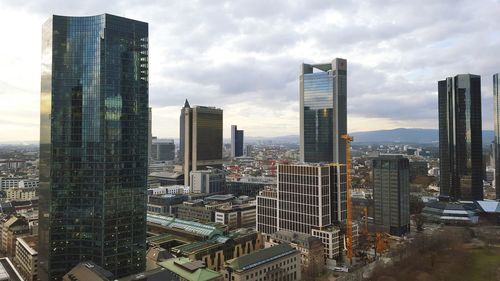 Cityscape against cloudy sky