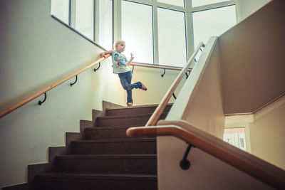 Low angle view of woman on staircase at home