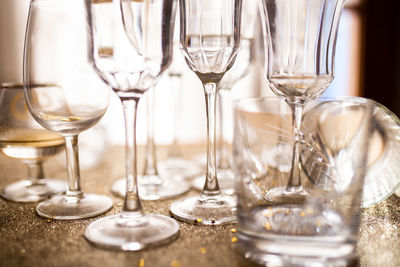 Several champagne glasses over gold christmas background. celebrating new year concept.