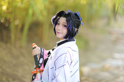 Portrait of teenage girl standing on land