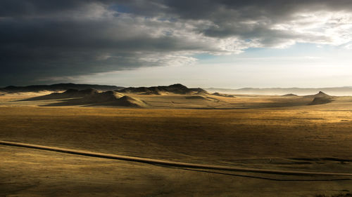 Steppe panorama with hills and clouds