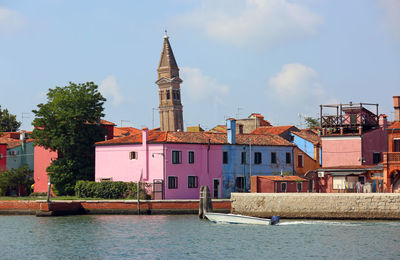 Canal amidst buildings against sky