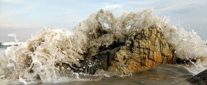 Close-up of wave splashing on beach