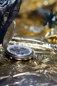 Close-up of pocket watch on table