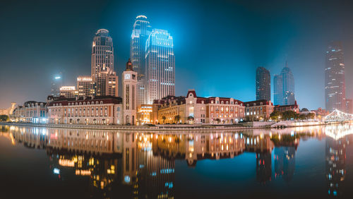 Reflection of buildings in city at night