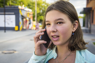 Close-up of teenage girl using mobile phone