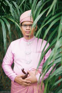 Portrait of new groom in traditional malay dress