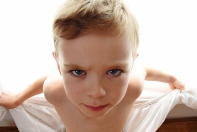 Close-up portrait of boy against white background