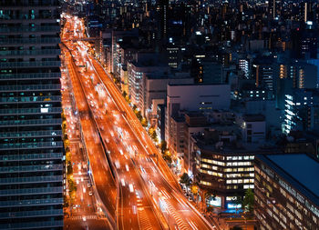 High angle view of vehicles moving on city street at night