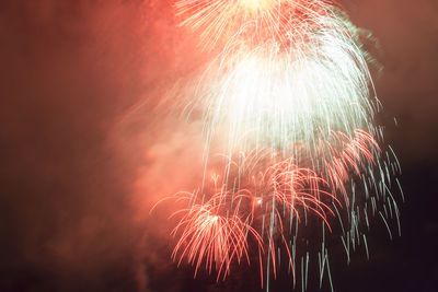 Low angle view of firework display at night