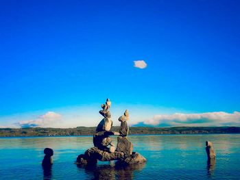 Scenic view of sea against blue sky