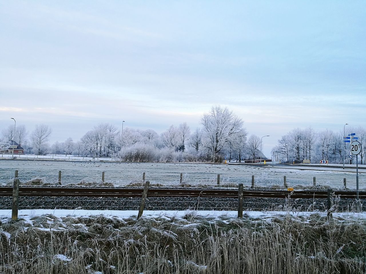 sky, water, cold temperature, tree, nature, rail transportation, bridge - man made structure, no people, snow, cloud - sky, day, outdoors, winter, city, architecture