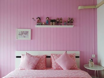 People relaxing on bed against wall at home