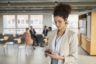 Midsection of woman using mobile phone