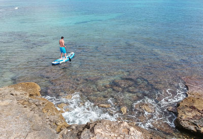 High angle view of man swimming in sea