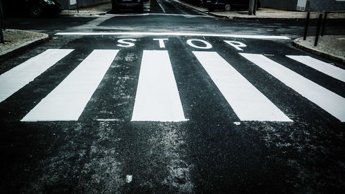 High angle view of zebra crossing with stop sign on road