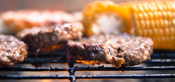 Close-up of meat and corn on barbecue grill