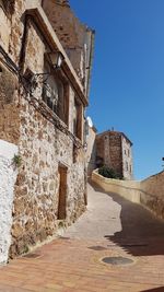 Low angle view of old building against blue sky