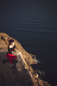 Portrait of a pirate woman at the beach. in anticipation of a pirate ship, sunset