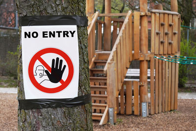 Close-up of warning sign on wood