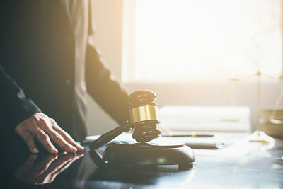 Midsection of lawyer working at desk in office