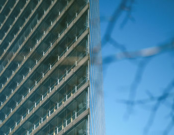 Low angle view of modern building against blue sky