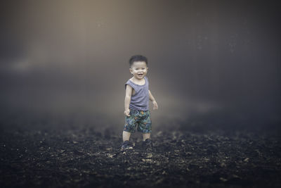 Cute boy standing on field