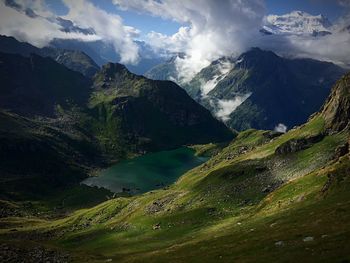 Scenic view of mountains against cloudy sky