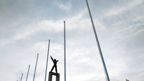 Low angle view of silhouette statue against sky