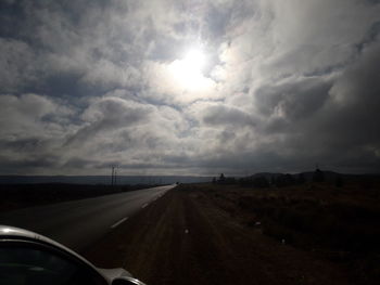 Road against sky seen through car windshield