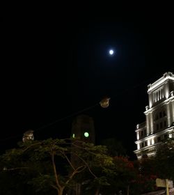 Low angle view of illuminated building against sky