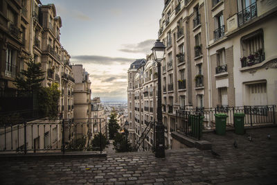 Street amidst buildings in town against sky