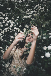 Midsection of woman holding plant