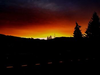 Scenic view of silhouette landscape against sky at sunset