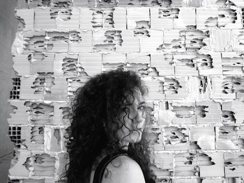 Portrait of woman standing against wall in store