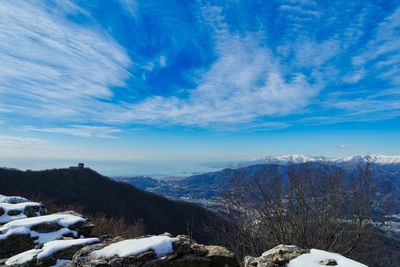 Scenic view of snowcapped mountains against blue sky