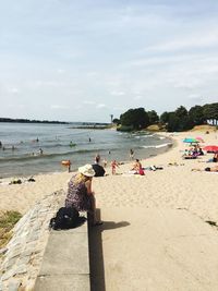 People on beach against sky