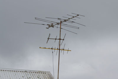 Low angle view of communications tower against sky