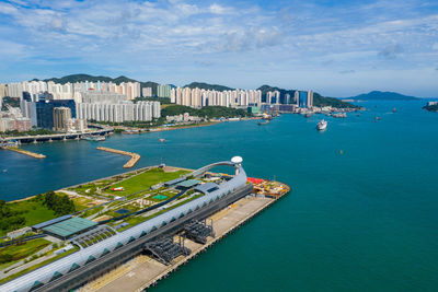 High angle view of bay and buildings against sky