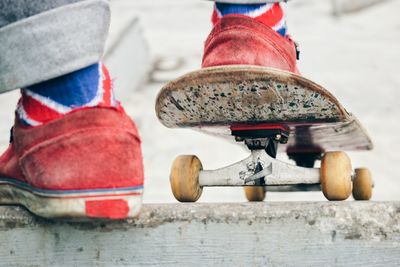 Low section of man skateboarding on road