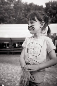 Girl with face paint standing outdoors