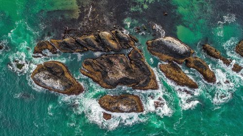 Aerial view of rock formations in sea