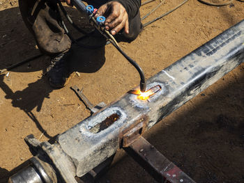 High angle view of man working on metal