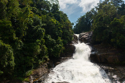 Aerial drone of waterfall in the tropical mountain jungle. bopath falls, sri lanka.