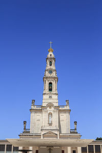 Low angle view of church against clear blue sky