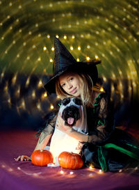 Portrait of little witch with dog