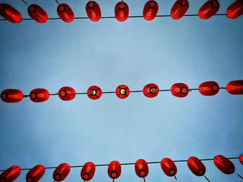 Low angle view of lanterns hanging against sky