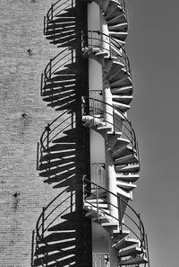 Spiral staircase outside against wall